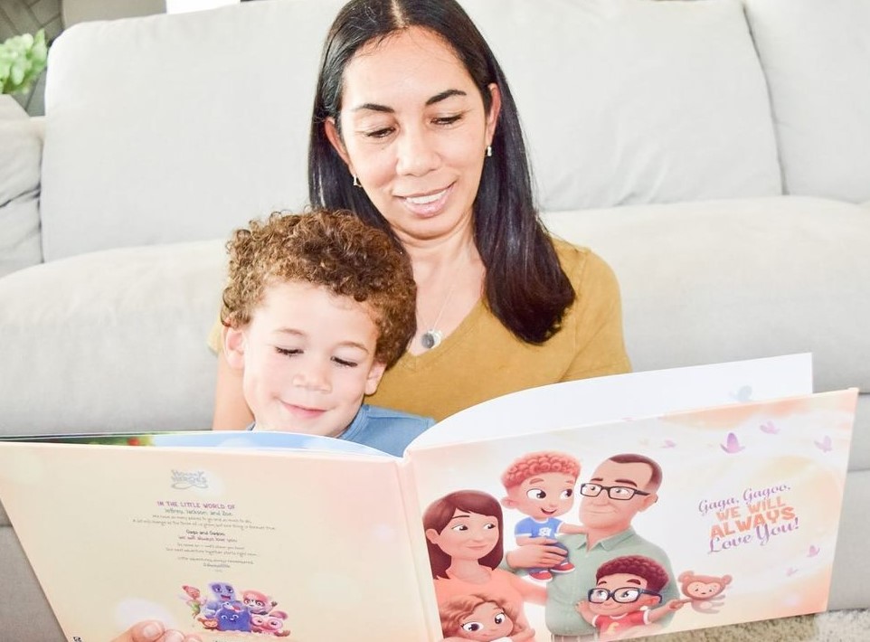 A grandmother reading a Hooray Heroes personalized book for grandparents and up to three children to her grandson.