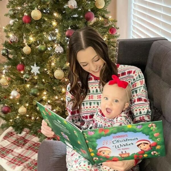 A mother reads a Hooray Heroes personalized Christmas book to her daughter, the perfect xmas gift.