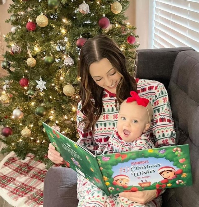 A mother reads a Hooray Heroes personalized Christmas book to her daughter, the perfect xmas gift.
